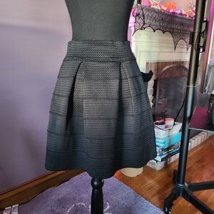 Flattering black pleated skirt.